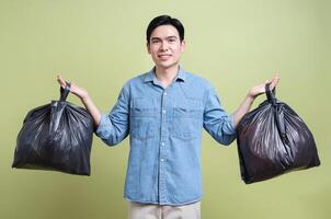 Photo of young Asian man on green background