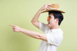 Photo of young Asian man on green background