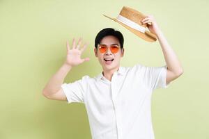 Photo of young Asian man on green background