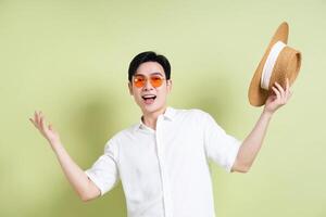 Photo of young Asian man on green background