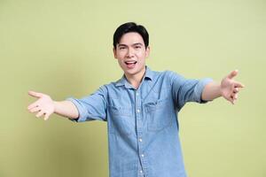 Photo of young Asian man on green background