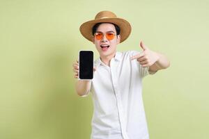 Photo of young Asian man on green background