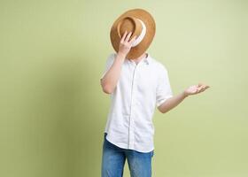 Photo of young Asian man on green background