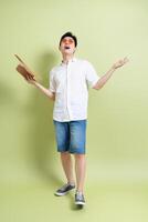 Photo of young Asian man on green background