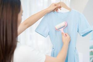 Young Asian woman cleaning dress photo