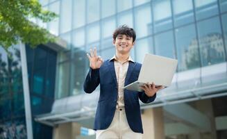 Portrait of young Asian businessman outside photo