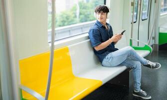 Young Asian man on the metro photo