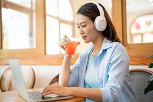 Photo of young Asian woman at coffee shop