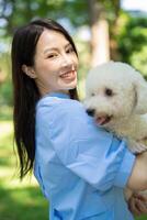 Photo of young Asian girl with her dog