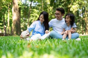 Photo of young Asian family at park