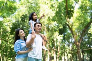 Photo of young Asian family at park