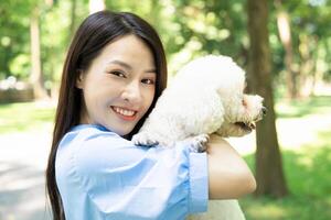 Photo of young Asian girl with her dog