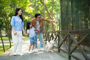 Photo of young Asian family at park