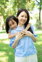 Photo of Asian mother and daughter at park