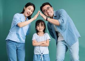 Photo of young Asian family on background