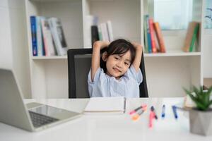 Photo of young Asian baby girl studying at home