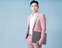 Photo of young Asian businessman wearing pink suit on background