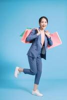 Photo of young Asian businesswoman on background