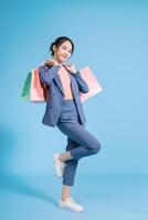 Photo of young Asian businesswoman on background