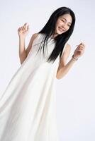 Photo of young Asian girl wearing dress on background