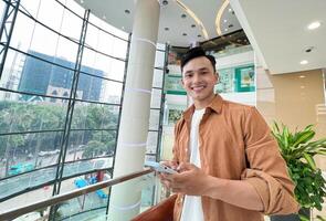 Portrait of young Asian man outside photo