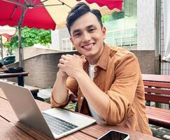 Portrait of young Asian man outside photo