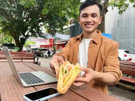 Portrait of young Asian man outside photo