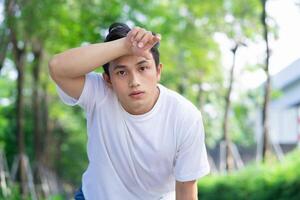 Portrait of young Asian man outside photo