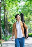 Portrait of young Asian man outside photo