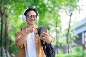 Portrait of young Asian man outside photo