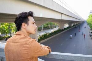 Portrait of young Asian man outside photo