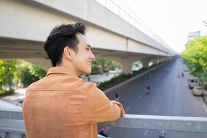 Portrait of young Asian man outside photo