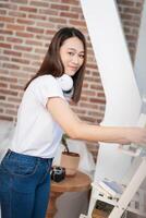 Photo of young Asian woman at home