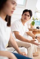 Photo of young Asian couple at home