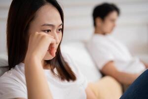 Photo of young Asian couple at home