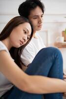 Photo of young Asian couple at home