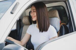 Photo of young Asian woman with her truck