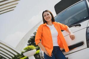 Photo of young Asian woman with her truck