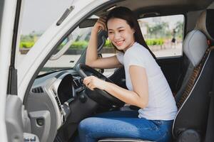 Photo of young Asian woman with her truck