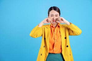 Photo of young Asian businesswoman with colorful suit on background