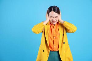 Photo of young Asian businesswoman with colorful suit on background