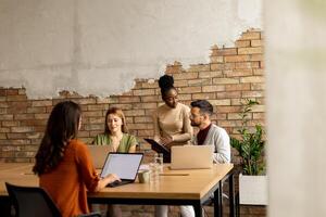 Young multiethnic startup team working in the rustic office photo