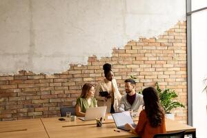 Young multiethnic startup team working in the rustic office photo
