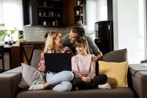 Family Bonding Time With Laptop in Cozy Home Setting photo