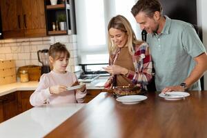 Joyful Family Enjoying Homemade Chocolate Cake in Cozy Kitchen photo