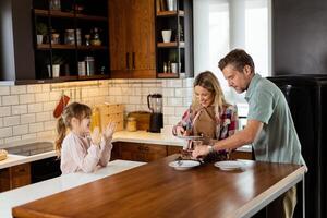 Joyful Family Enjoying Homemade Chocolate Cake in Cozy Kitchen photo