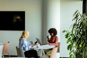 Joyful Office Coffee Break With Colleagues Sharing a Laugh in Bright Workspace photo