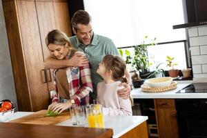 Family chatting and preparing food around a bustling kitchen counter filled with fresh ingredients and cooking utensils photo