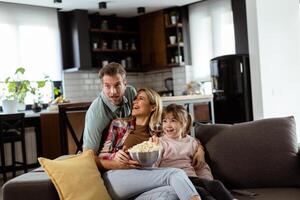 Family Movie Night, Engrossed in Thrilling Scenes at Home photo