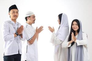 Asian People Friends Forgiving Each Other during Eid Mubarak Celebration photo